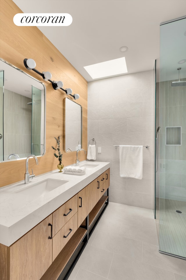 64 2nd St, New York City, NY 11231 - bathroom featuring double vanity, a tile shower, tile patterned flooring, a skylight, and tile walls
