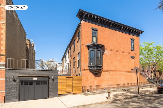64 2nd St, New York City, NY 11231 - view of building exterior with a garage and driveway