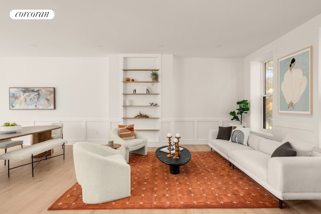 64 2nd St, New York City, NY 11231 - living room with wood finished floors, a decorative wall, a wainscoted wall, and built in features
