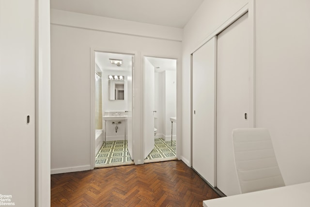 hall featuring baseboards