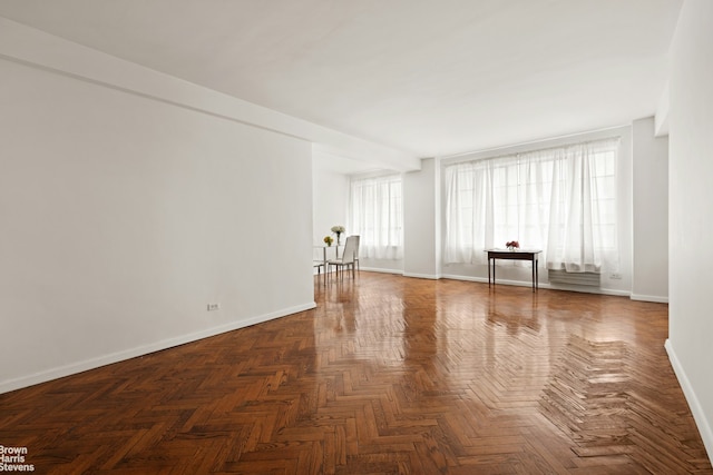 spare room with baseboards