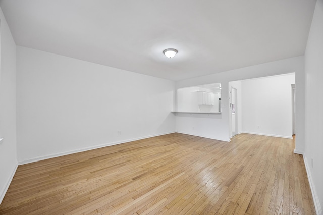 302 96th St Unit 2-W, New York City, NY 11209 - spare room with light wood-style flooring and baseboards