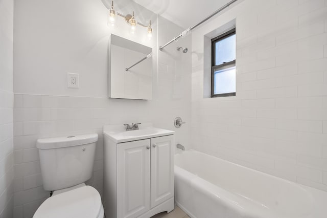 302 96th St Unit 2-W, New York City, NY 11209 - bathroom featuring vanity, shower / bathtub combination, and tile walls