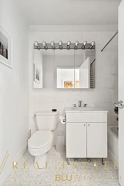 99 John St Unit Ph-9, New York City, NY 10038 - full bathroom featuring vanity, toilet, shower / tub combination, and tile patterned flooring