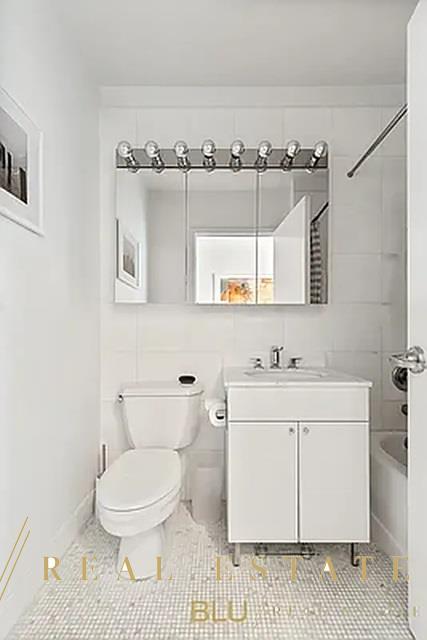 99 John St Unit Ph-9, New York City, NY 10038 - full bath with vanity, shower / bath combination, and tile patterned floors