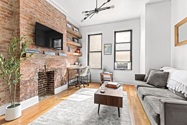 living room featuring baseboards, a chandelier, cooling unit, crown molding, and hardwood / wood-style floors