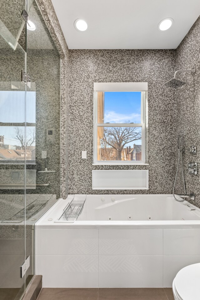 333 W 262nd St, New York City, NY 10471 - bathroom featuring a wealth of natural light, a shower stall, and a jetted tub