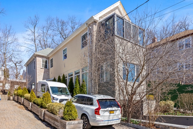 333 W 262nd St, New York City, NY 10471 - view of side of property featuring brick siding and stucco siding