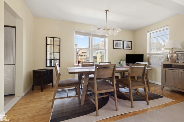 800 Grand Concourse Unit 3Ln, New York City, NY 10451 - dining room featuring a chandelier, light wood-type flooring, and baseboards