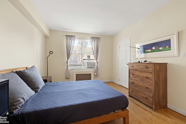 bedroom featuring light wood-type flooring and baseboards