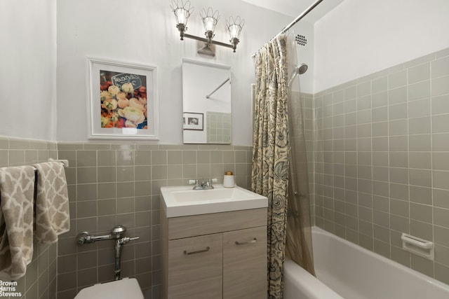 full bathroom with tile walls, shower / bath combination with curtain, vanity, and toilet
