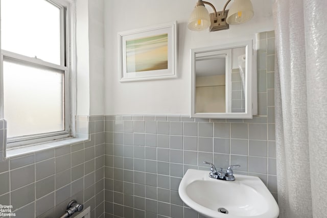 full bathroom with a sink and tile walls