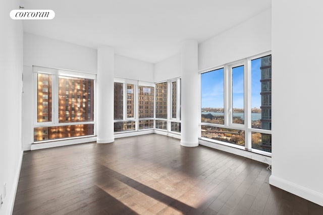 unfurnished sunroom with a water view