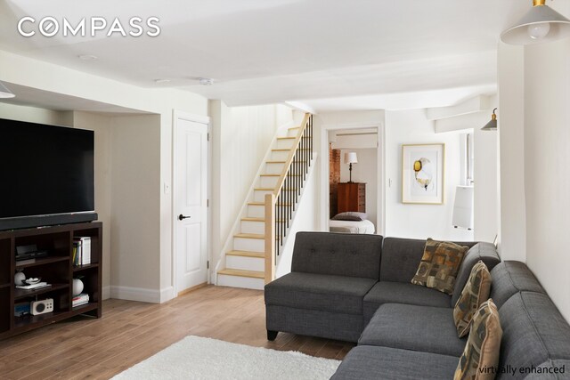 330 E 94th St Unit 1Ab, New York City, NY 10128 - living room featuring wood finished floors, stairway, and baseboards