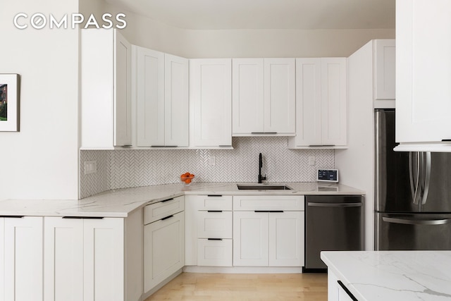 330 E 94th St Unit 1Ab, New York City, NY 10128 - kitchen featuring appliances with stainless steel finishes, a sink, light stone counters, and decorative backsplash