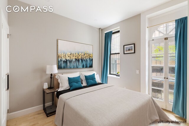 330 E 94th St Unit 1Ab, New York City, NY 10128 - bedroom featuring access to exterior, light wood-style flooring, and baseboards