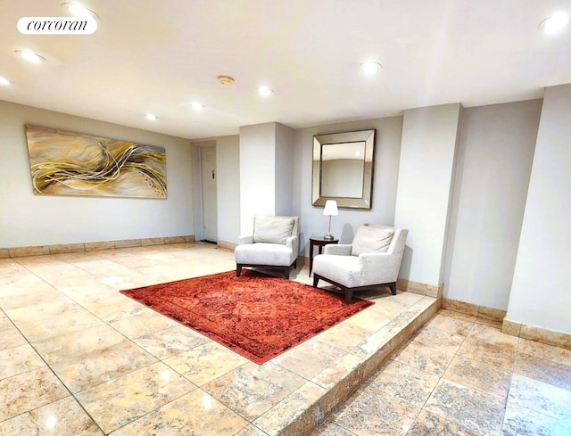 living area with baseboards and recessed lighting