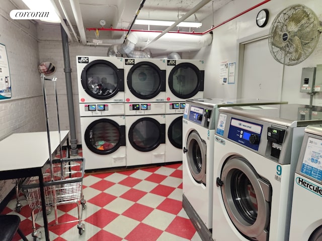 community laundry room featuring tile patterned floors, washing machine and clothes dryer, and stacked washer / dryer