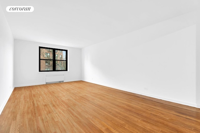 empty room with light wood-style floors and baseboards