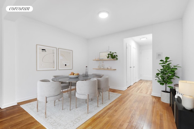 dining room with hardwood / wood-style floors and baseboards