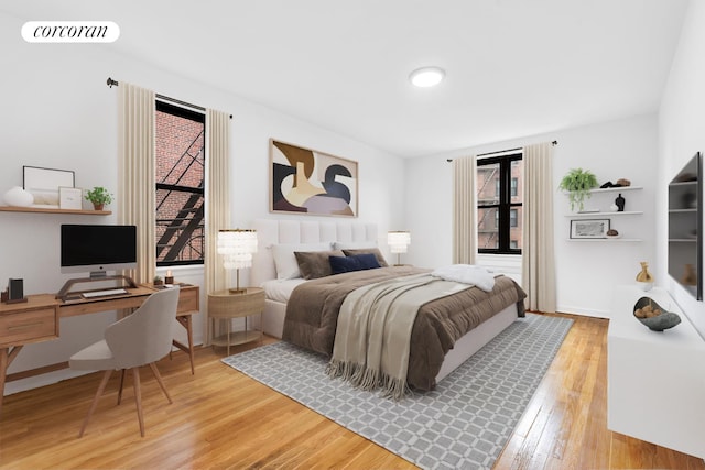 bedroom featuring wood finished floors and an office area
