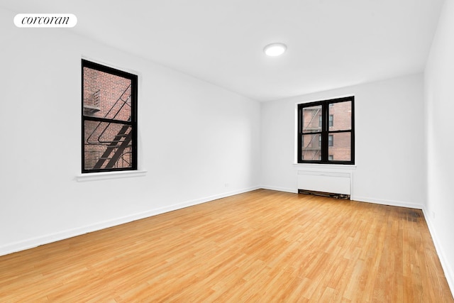 445 W 240th St Unit 4A, New York City, NY 10463 - spare room with wood finished floors and baseboards