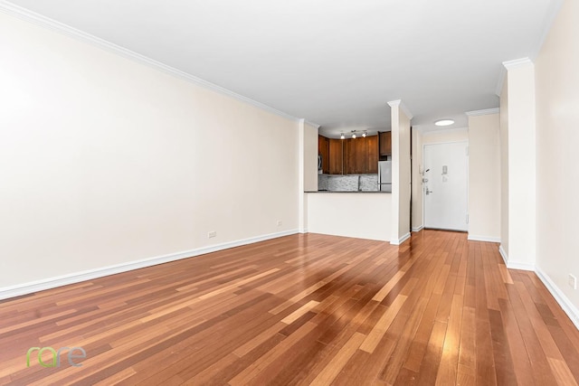 340 E 93rd St Unit 28D, New York City, NY 10128 - unfurnished living room featuring crown molding, light wood-style flooring, and baseboards
