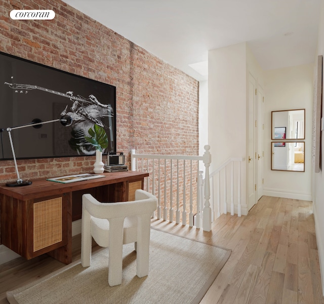 313 Troy Ave, New York City, NY 11213 - home office featuring wood finished floors, brick wall, and baseboards