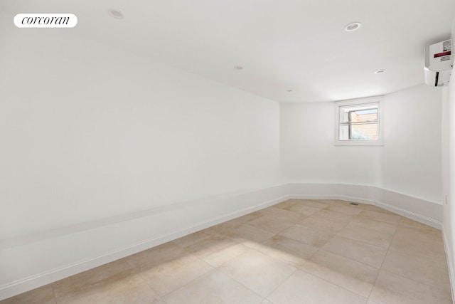 313 Troy Ave, New York City, NY 11213 - unfurnished room with baseboards, light tile patterned floors, an AC wall unit, and recessed lighting