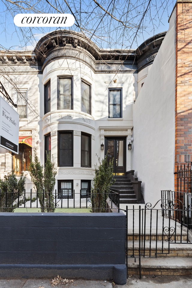 313 Troy Ave, New York City, NY 11213 - view of front of home featuring a fenced front yard and stone siding