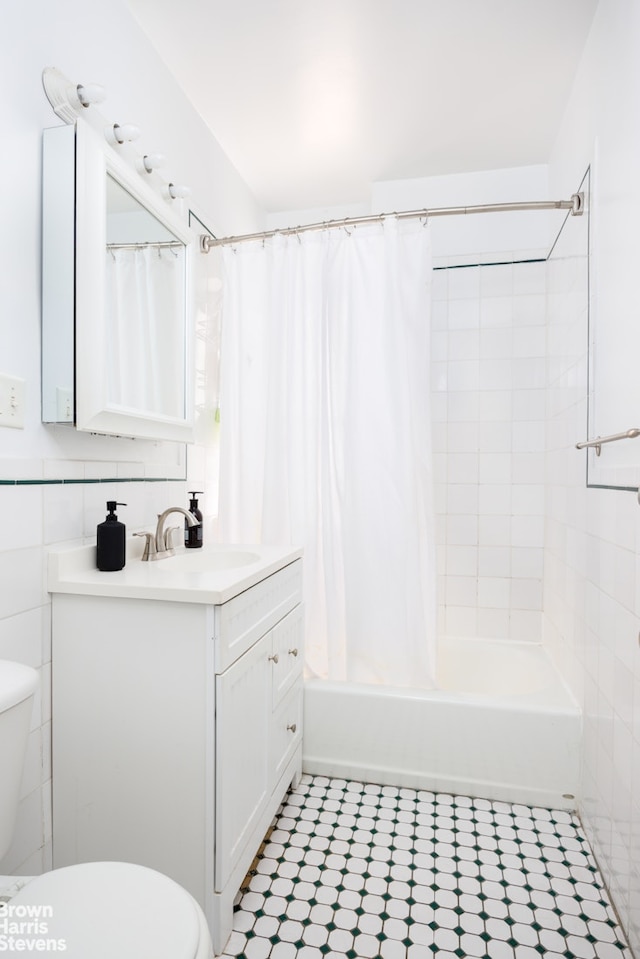 full bath featuring vanity, toilet, tile patterned floors, and shower / tub combo