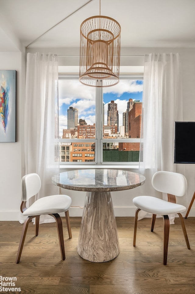 432 W 52nd St Unit 7H, New York City, NY 10019 - dining room featuring wood finished floors and baseboards