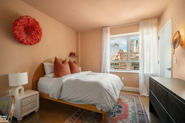 432 W 52nd St Unit 7H, New York City, NY 10019 - bedroom with baseboards and wood finished floors