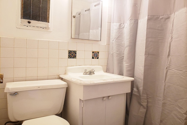 full bath featuring tile walls, toilet, and vanity