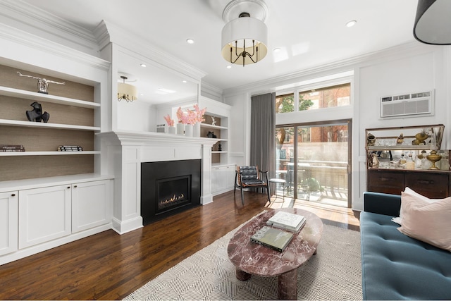 428 W 23rd St Unit 1A, New York City, NY 10011 - living room featuring crown molding, a warm lit fireplace, dark wood-style floors, an AC wall unit, and built in shelves