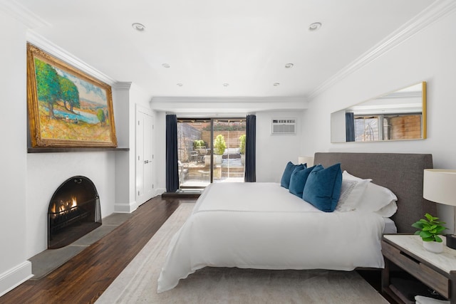 428 W 23rd St Unit 1A, New York City, NY 10011 - bedroom with a lit fireplace, crown molding, wood finished floors, baseboards, and an AC wall unit