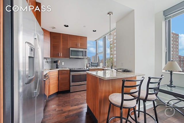 108-20 71st Ave Unit 4C, New York City, NY 11375 - kitchen with a view of city, appliances with stainless steel finishes, a peninsula, dark wood finished floors, and backsplash