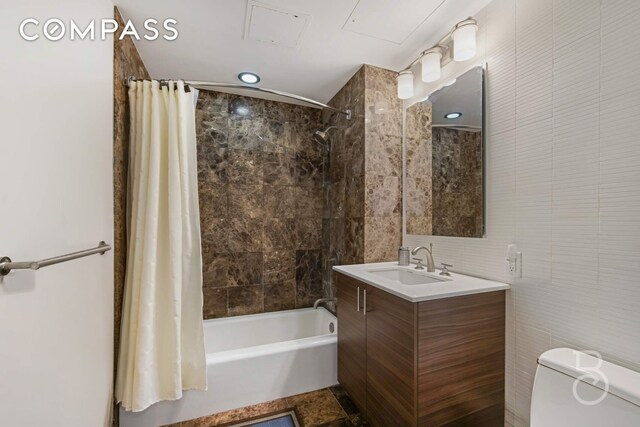 108-20 71st Ave Unit 4C, New York City, NY 11375 - full bathroom featuring shower / tub combo, vanity, tile walls, and toilet