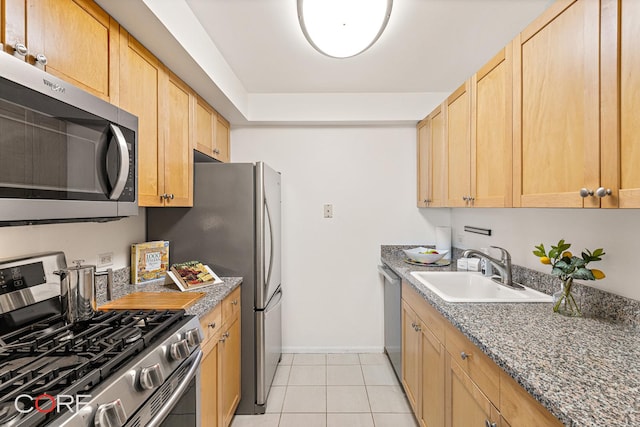 300 W 145th St Unit 6M, New York City, NY 10030 - kitchen with appliances with stainless steel finishes, a sink, baseboards, light brown cabinetry, and light tile patterned floors