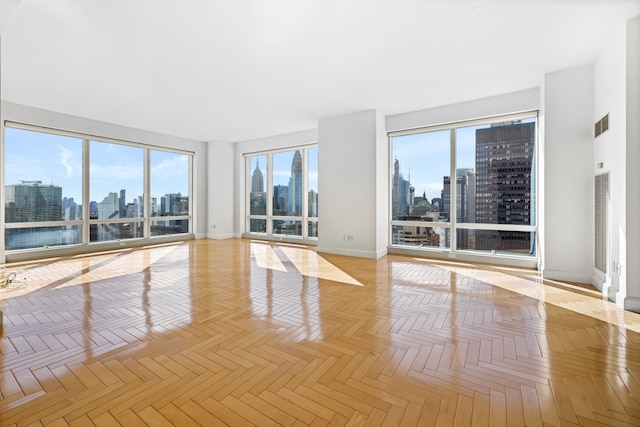 845 United Nations Plz Unit 52C, New York City, NY 10017 - spare room with a view of skyline and baseboards