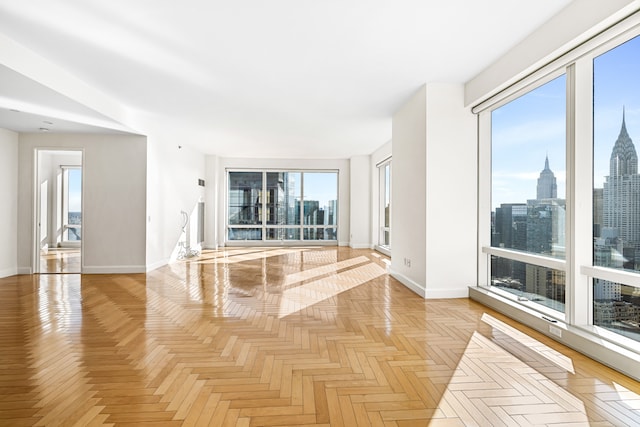 845 United Nations Plz Unit 52C, New York City, NY 10017 - unfurnished room featuring baseboards and a skyline view