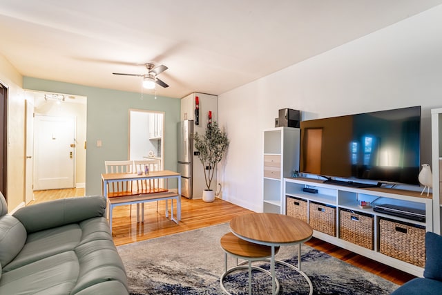 living area with a ceiling fan and light wood finished floors