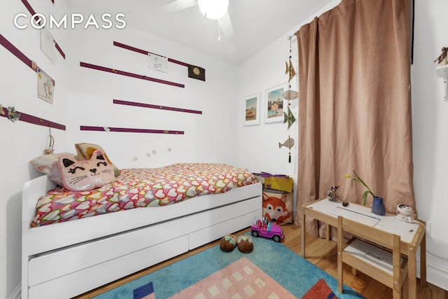 bedroom with ceiling fan and wood finished floors