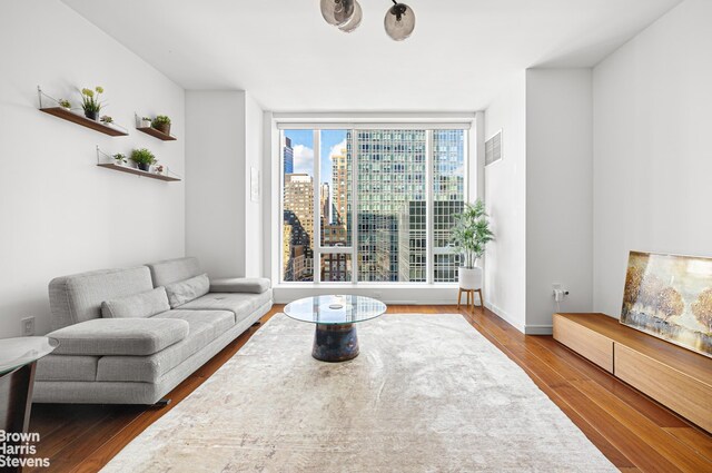 1 W End Ave Unit 11L, New York City, NY 10023 - living area with a view of city, visible vents, and wood finished floors