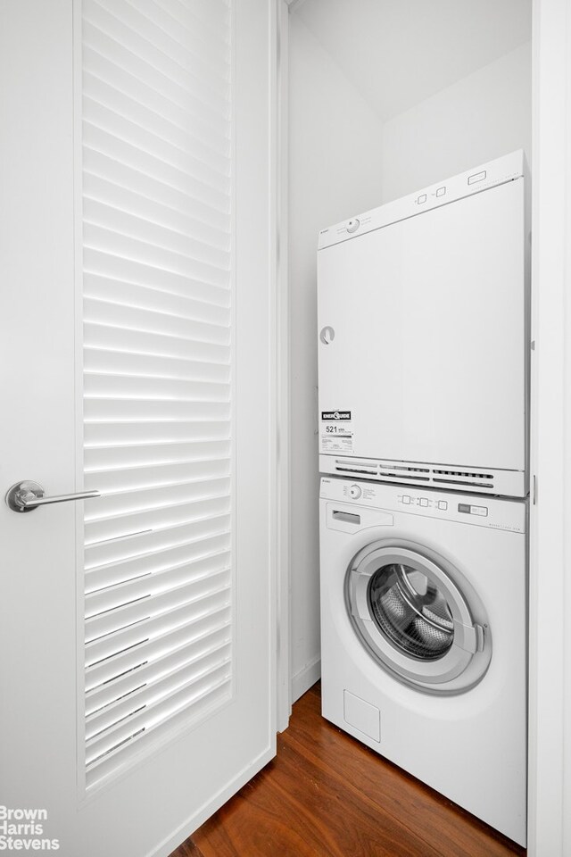 1 W End Ave Unit 11L, New York City, NY 10023 - washroom featuring stacked washer / dryer, laundry area, and dark wood-style floors