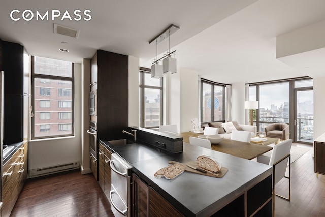 kitchen featuring plenty of natural light, baseboard heating, and visible vents