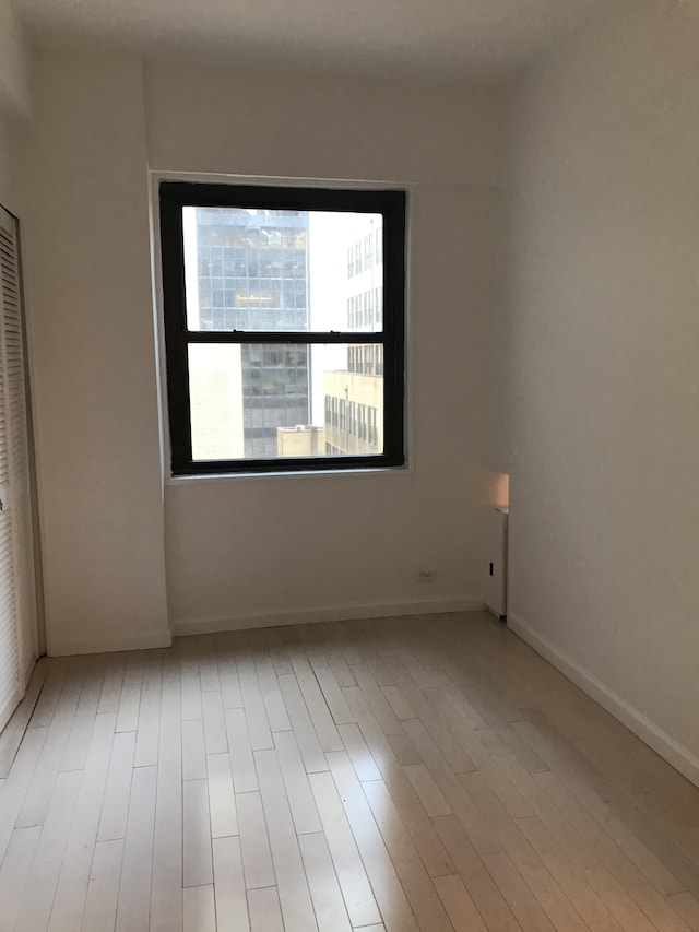 58 W 58th St Unit 9D, New York City, NY 10019 - unfurnished room featuring wood finished floors and baseboards