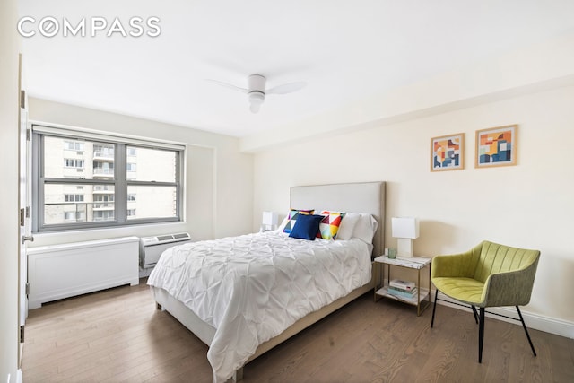 100 W 93rd St Unit 11J, New York City, NY 10025 - bedroom featuring wood finished floors, an AC wall unit, and ceiling fan