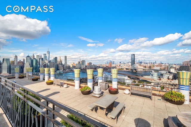 view of patio / terrace with a skyline view and a water view
