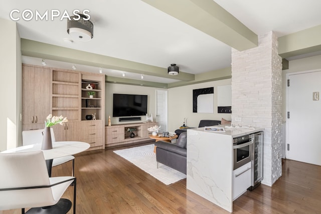 living room with wine cooler and wood finished floors